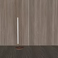 Slim Floor Lamp With Round Base In Minimalist Room With Wooden Wall And Floor
