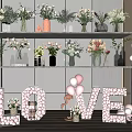 Colorful Flowers In Different Style Vases Display On Shelves With LOVE Letters