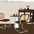 White Round Dining Table with Two Rattan Back Chairs Leather Seats and Cabinet Decorations