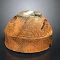 Traditional Terracotta Vessel With Cracked Surface And Intricate Geometric Patterns