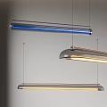 Three Modern Pendant Lights Hanging From Ceiling With Metal And Glass Illuminated Design