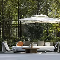 Stylish Modern Outdoor Sofa Set In Patio Space With Coffee Table And Lush Greenery