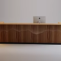Modern Light Wood Reception Desk With Computer Monitor And Accompanying Chair