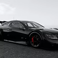 Black Racing Car With Rear Wing Red Wheels And Sleek Body Design On Open Road