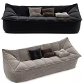 Modern Three Seater Sofa With Black Gray Upholstery Stitched Details And Decorative Cushions