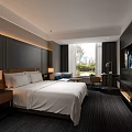 Modern Hotel Guest Room with King Bed White Bedding Dark Furniture and Large Window
