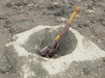 Axe Stuck in a Circular Stone Pit Surrounded by Sandy Ground and Stones 3d model