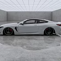 White BMW Sports Coupe in Modern Interior Space with Sleek Concrete Floor and Grid Ceiling