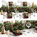 Christmas Themed Tableware Set With Greenery Red Placemats Gold Cutlery Wine Glasses And Oranges