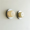 Two Minimalist Wall Sconces With Cream Lampshade And Round Base On Light Colored Wall