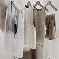 White Clothes Organized On Hangers With Silver Storage Bins And Light Colored Background