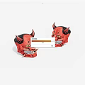 Two Red Devil Masks With Horns And Yellow Eyes As Decorative Ornaments