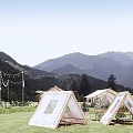 Scenic Mountain View Campsite With Tents Green Lawn And Outdoor Seats