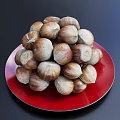 Red Plate Decoration With Pile of Fresh Chestnuts on Dark Background
