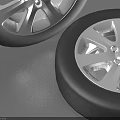Two Car Tires With Silver Alloy Rims Displayed On Gray Background