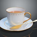White Teacup With Gold Rim And Decorations On Matching Saucer With Gold Spoon