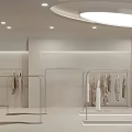 Modern Fashion Gallery Interior With Mannequins Clothing Displays Warm Lighting And Small Tree