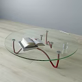 Round Glass Coffee Table With Red Metal Legs Open Book Stack And Glass Cup