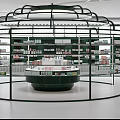 Elegant Green Cosmetic Store Interior With Circular Counter And Product Shelves