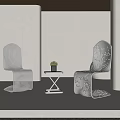 Modern Metallic Table And Chair Set With Sleek Lines And Small Potted Plant