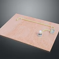 Brown Wooden Board With Yellow Tube Connected To White Knob And Gray Component