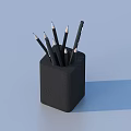 Black Fabric Pencil Holder With Multiple Pencils And Pen On Light Blue Background