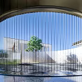 Contemporary Garden Landscape With Circular Metal Screen Vertical Lines Green Tree And Water Feature