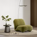 Green Ribbed Velvet Single Seater Sofa With Potted Plant And Round Rug On Wooden Floor