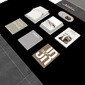 Various Designed Books Magazines On Black Tabletop With Decorative Tray And Artistic Covers