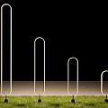 Commercial Equipment Metal Ring Structures With Various Heights And Black Bases On Green Grass