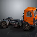 Orange Truck Chassis With Cab And Large Wheels On Dark Background