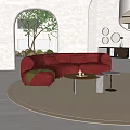 Curved Red Sofa with Cushions Round Coffee Table and Green Plant in Modern Living Room