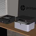 HP Office Appliances Two Printers Black And White Models On Desk