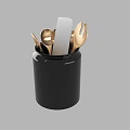 Black Kitchen Utensil Holder with Golden Spoon Fork and White Knife