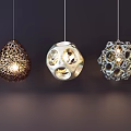 Modern Pendant Lights with Three Unique Decorative Designs Hanging Against Dark Background Lit and Stylish