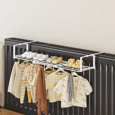 Striped Brown And White Patterned Clothes On Hanging Rack Above Black Radiator With Shoes 3d model