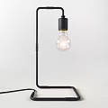 Minimalist Black Metal Table Lamp with Curved Stand and Transparent Bulb for Home Office