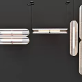 Modern Elongated Glass Chandeliers Hanging In Multiple Designs On Dark Background