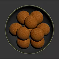 Crispy Orange Food Balls Served in Black Bowl with Crumbly Surface Texture