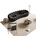 Modern Living Room With Black Tufted Sofa Round Coffee Table Red Armchair And Rug