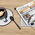 A Cup of Coffee with Latte Art on Saucer and Spoon Next to Newspaper
