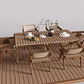 Outdoor Wooden Table And Chair Set With Wicker Backrests And Dinnerware On Terrace
