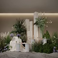 Modern Floral Display With White Columns Green Plants Purple Flowers Marble Countertops And Lighting
