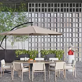 Outdoor Chairs Set With Table And Umbrella In Patio Garden With Greenery And Lattice Wall