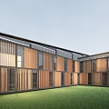 Modern Detached Villa Exterior With Wooden Metal Elements Large Glass Windows Enclosed Lawn Courtyard