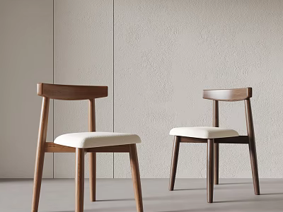 Minimalist Wooden Dining Chairs With White Padded Seats Against Light Colored Walls 3d model