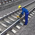 Industrial Railway Track Maintenance Equipment Being Used By Worker On Rail Line