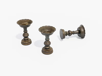 Three Bronze Candlesticks Displayed On White Background With Two Standing And One Overturned 3d model