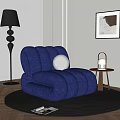 Blue Plush Single Sofa With Curved Design Black Floor Lamp Side Table And Wall Art
