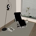 Modern Black Leather Lounge Chair in Minimalist Interior with Floor Fan Magazine and Potted Plant